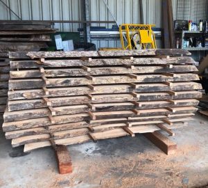 Milled and stacked timber slabs left to dry